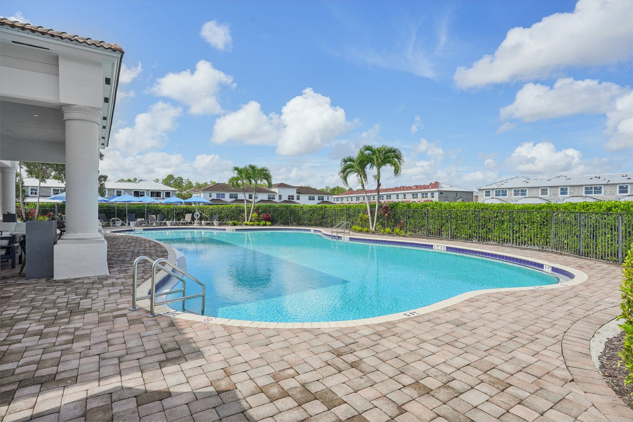 a swimming pool at a resort with palm trees